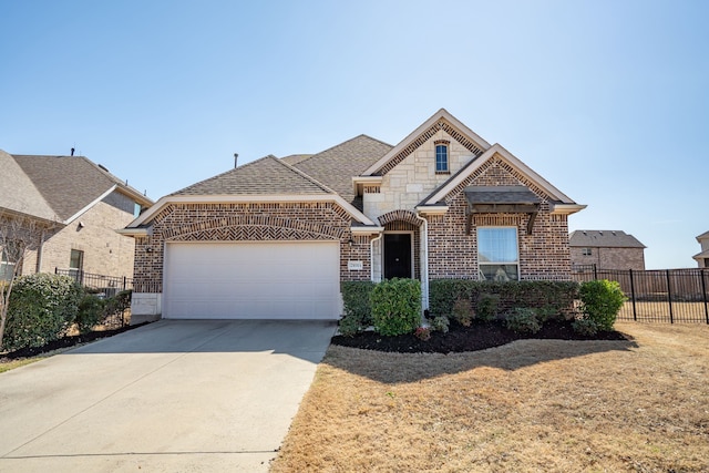 view of front of property with brick siding, concrete driveway, fence, a garage, and stone siding