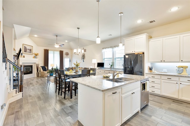 2101 Bishop Barrel Ln, Wylie, TX 75098 - kitchen with black fridge with ice dispenser, a sink, open floor plan, healthy amount of natural light, and recessed lighting