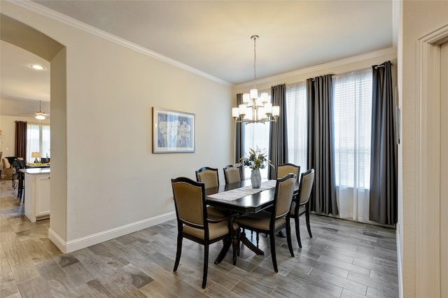 2101 Bishop Barrel Ln, Wylie, TX 75098 - dining room with a chandelier, arched walkways, baseboards, ornamental molding, and light wood finished floors