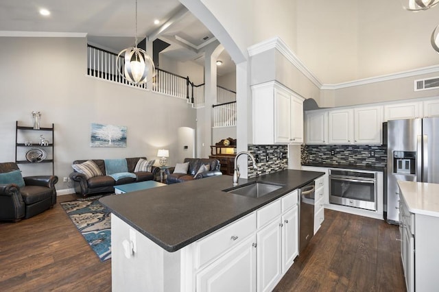 kitchen featuring open floor plan, appliances with stainless steel finishes, a sink, and visible vents