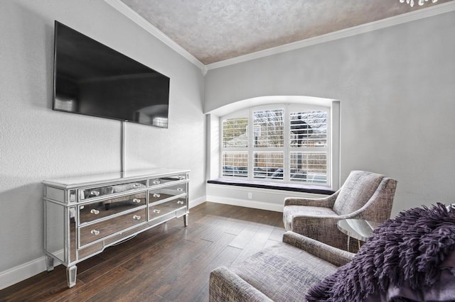 sitting room with a textured ceiling, ornamental molding, wood-type flooring, and baseboards