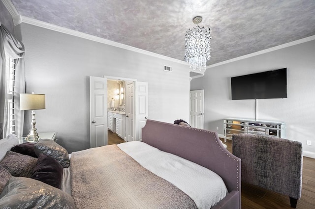 bedroom with baseboards, visible vents, ornamental molding, wood finished floors, and a notable chandelier