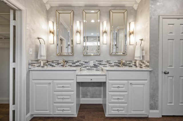 full bathroom featuring ornamental molding, wood finished floors, backsplash, and a sink