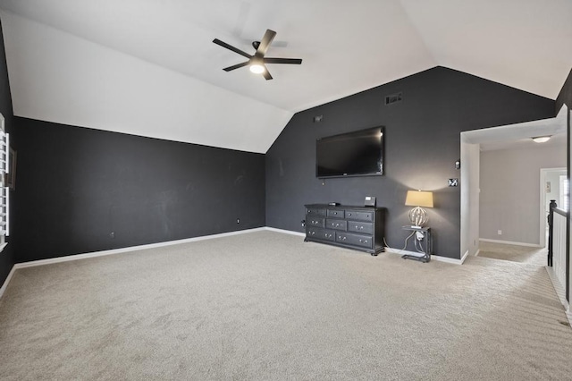 unfurnished living room with carpet flooring, a ceiling fan, visible vents, vaulted ceiling, and baseboards