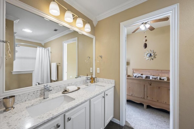 full bathroom featuring ceiling fan, double vanity, a sink, and crown molding