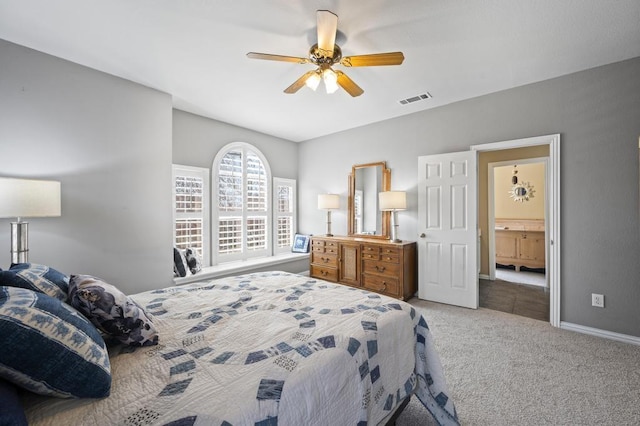 carpeted bedroom featuring a ceiling fan, visible vents, and baseboards