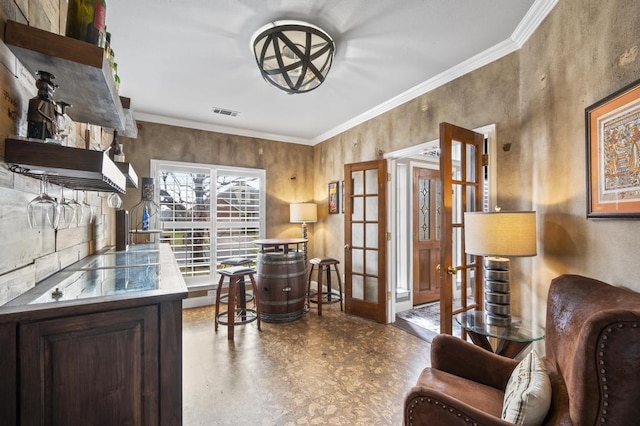 home office with french doors, ornamental molding, and visible vents