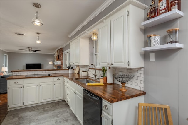 kitchen with butcher block counters, a sink, dishwasher, open shelves, and crown molding