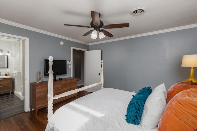 bedroom with dark wood-type flooring, connected bathroom, visible vents, and ornamental molding