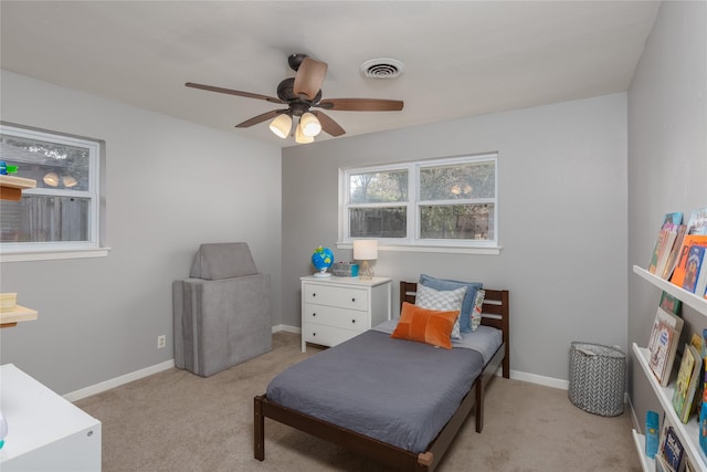 bedroom with light carpet, baseboards, visible vents, and a ceiling fan