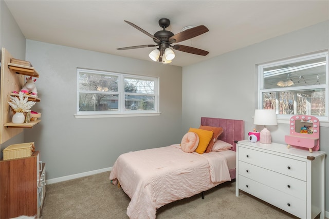 bedroom featuring light carpet, ceiling fan, and baseboards