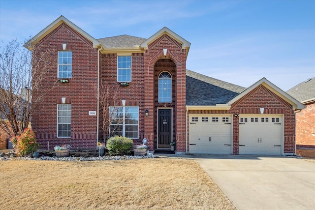 traditional-style house featuring a garage, brick siding, driveway, and a shingled roof