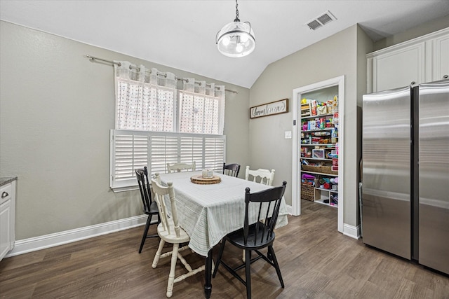 dining area featuring dark wood finished floors, visible vents, and baseboards