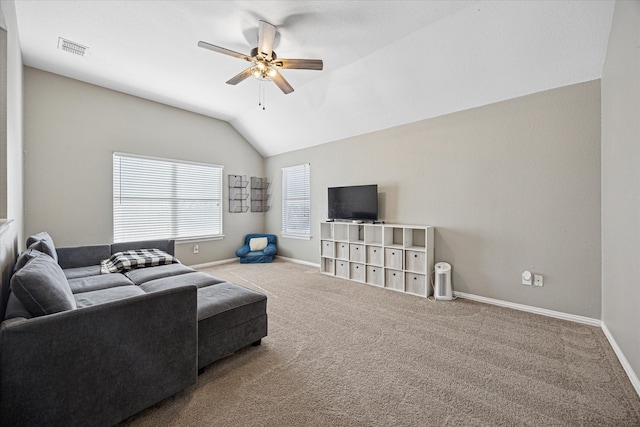 living area with baseboards, visible vents, vaulted ceiling, and carpet flooring