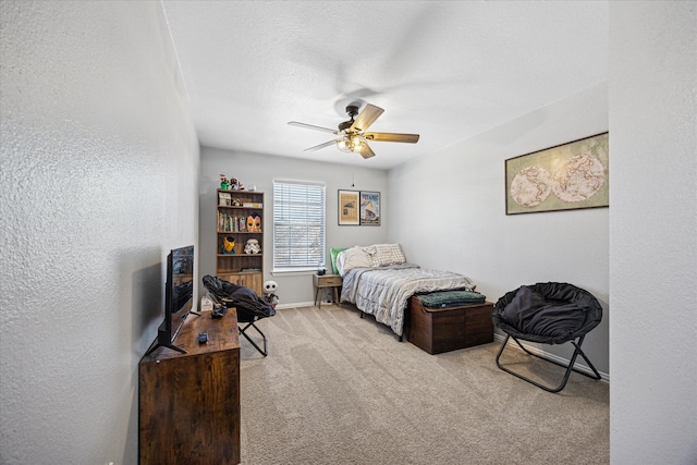 bedroom with a textured ceiling, carpet floors, a textured wall, and a ceiling fan