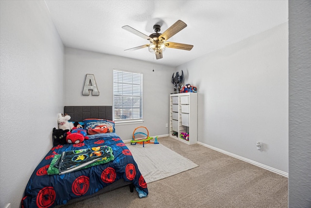 carpeted bedroom featuring ceiling fan and baseboards