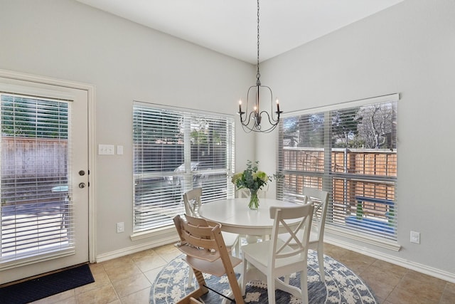 dining room with light tile patterned floors, baseboards, and a chandelier