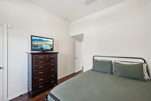 bedroom featuring dark wood-type flooring, visible vents, and baseboards