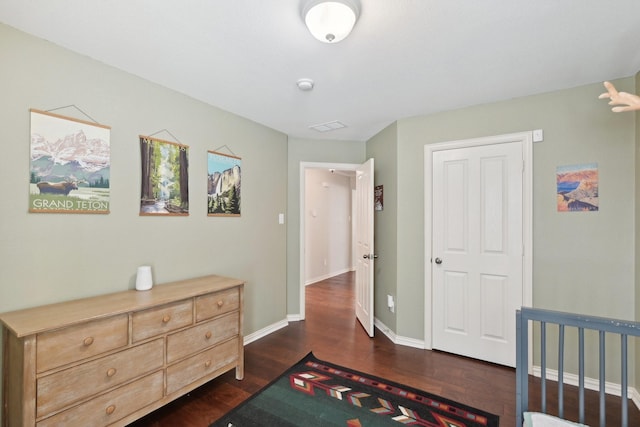 bedroom featuring dark wood-style floors and baseboards