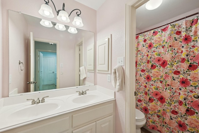 full bathroom with double vanity, a sink, toilet, and a shower with curtain