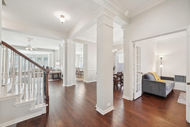 entrance foyer with baseboards, stairway, hardwood / wood-style floors, decorative columns, and crown molding