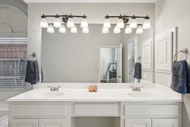 bathroom featuring a sink and double vanity