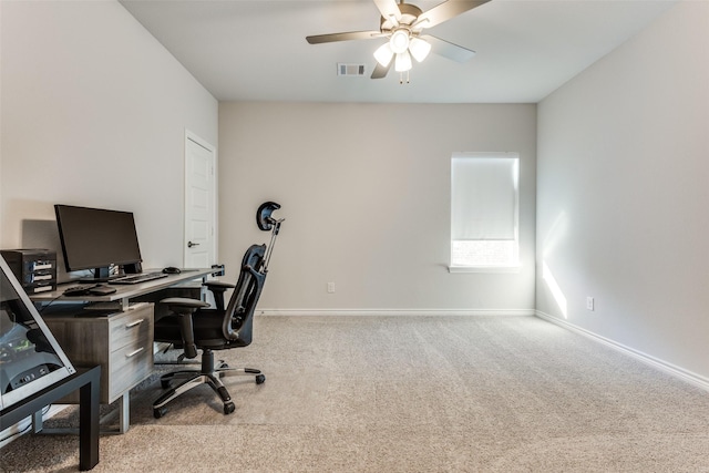 carpeted home office with visible vents, ceiling fan, and baseboards