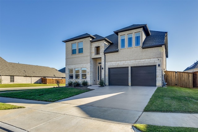 view of front of home with concrete driveway, stone siding, fence, a front yard, and brick siding