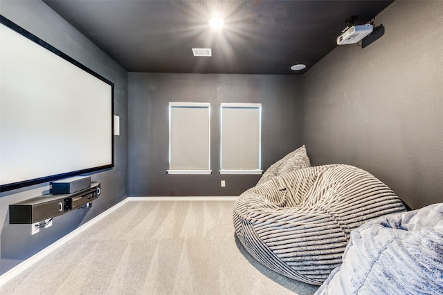 carpeted home theater with visible vents and baseboards