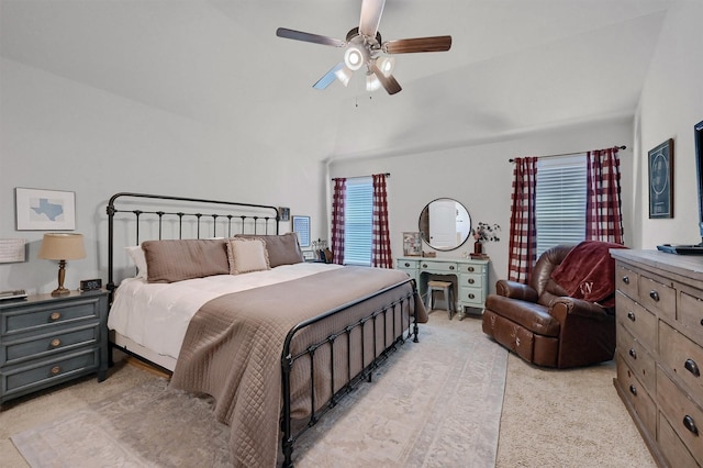 bedroom featuring lofted ceiling, light carpet, and a ceiling fan