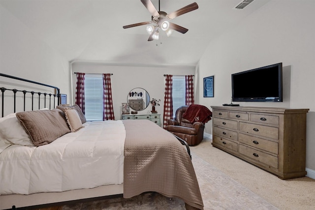 carpeted bedroom with lofted ceiling, ceiling fan, visible vents, and baseboards