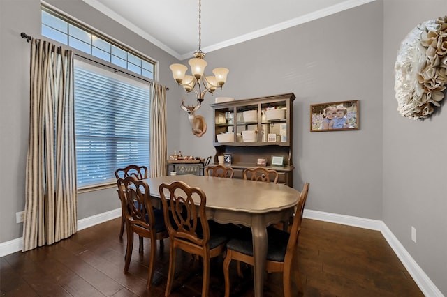 dining room with baseboards, dark wood-style flooring, and crown molding