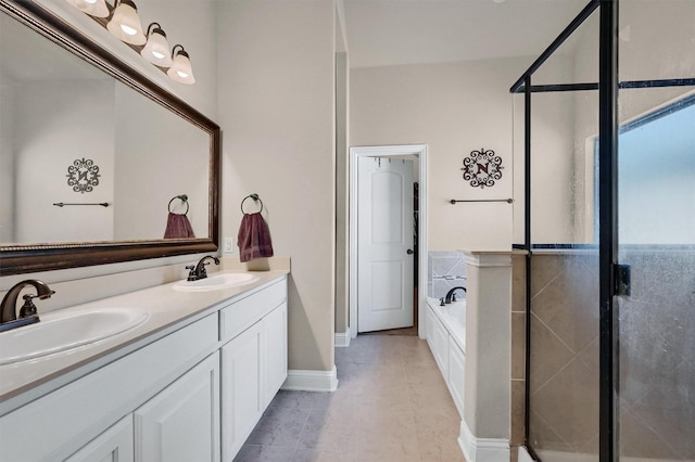 bathroom with double vanity, a garden tub, a shower stall, and a sink