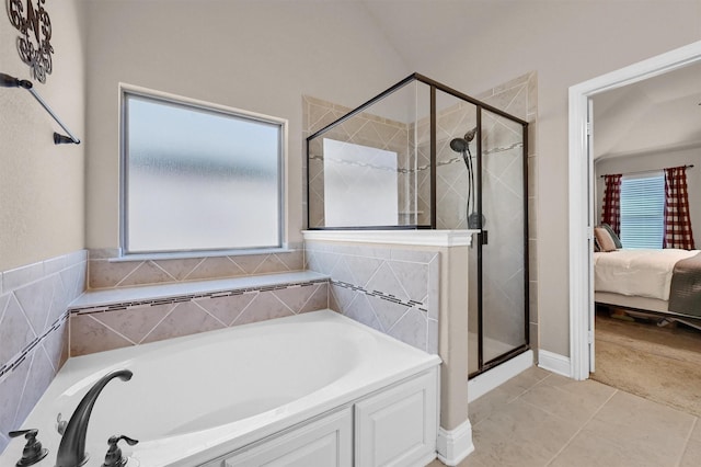 ensuite bathroom featuring a garden tub, a stall shower, ensuite bath, and tile patterned floors