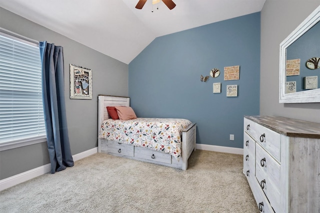 carpeted bedroom with a ceiling fan, lofted ceiling, and baseboards