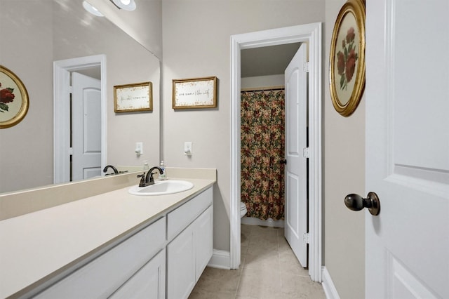 full bathroom with tile patterned flooring, baseboards, vanity, and toilet