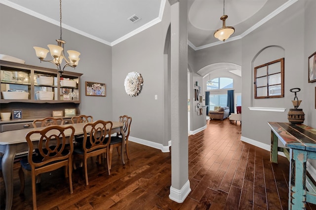 dining space with arched walkways, dark wood-style flooring, visible vents, and baseboards