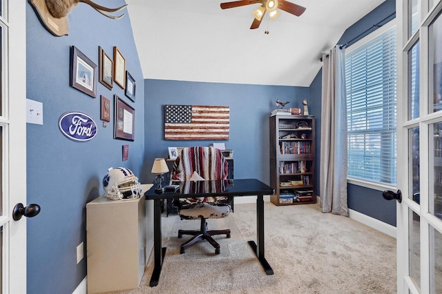 carpeted home office featuring lofted ceiling, french doors, ceiling fan, and baseboards