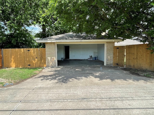 garage with driveway and fence