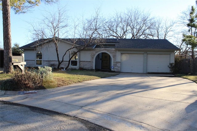 single story home with driveway, a front lawn, and an attached garage