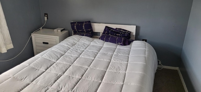 bedroom with carpet floors, washer / clothes dryer, and baseboards