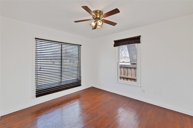 unfurnished room with ceiling fan, baseboards, and wood finished floors