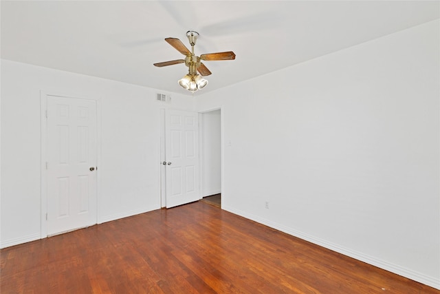 unfurnished bedroom with visible vents, ceiling fan, baseboards, and wood finished floors