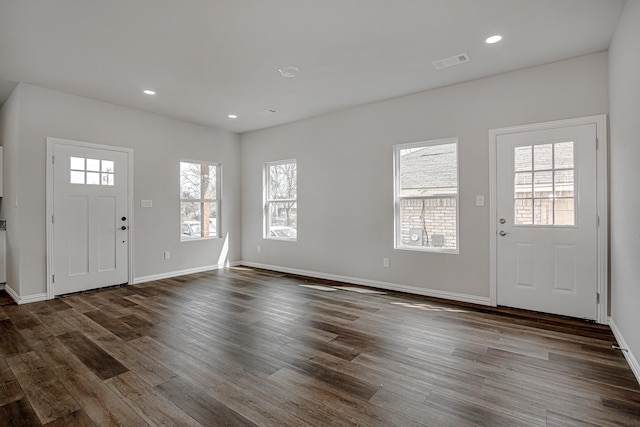 entrance foyer featuring baseboards, visible vents, dark wood-type flooring, and recessed lighting