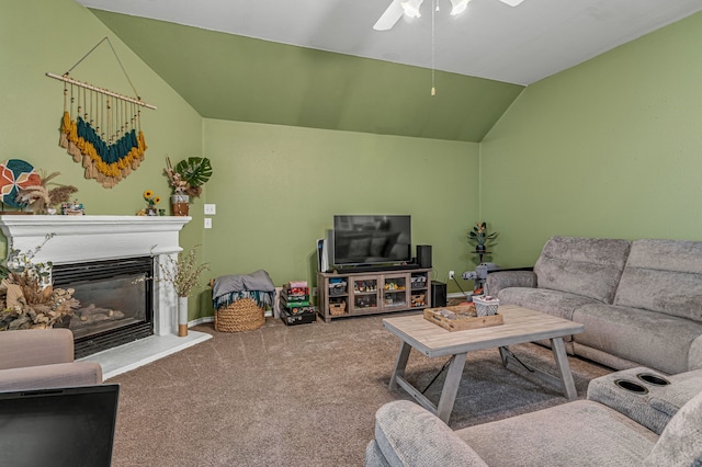 carpeted living room featuring lofted ceiling, a glass covered fireplace, and baseboards