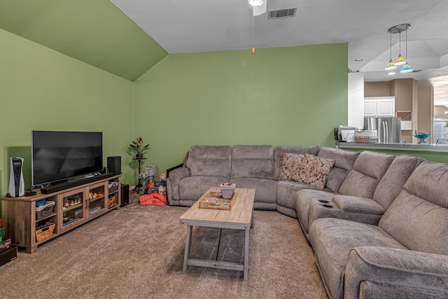 living room with carpet floors, visible vents, and vaulted ceiling