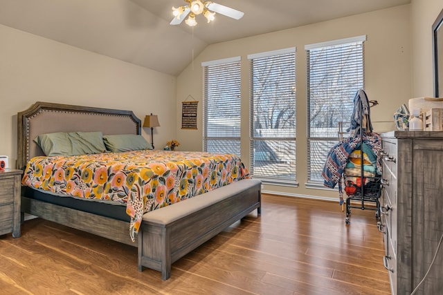 bedroom featuring vaulted ceiling, wood finished floors, and a ceiling fan