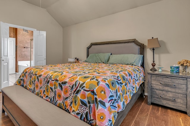 bedroom featuring lofted ceiling and wood finished floors