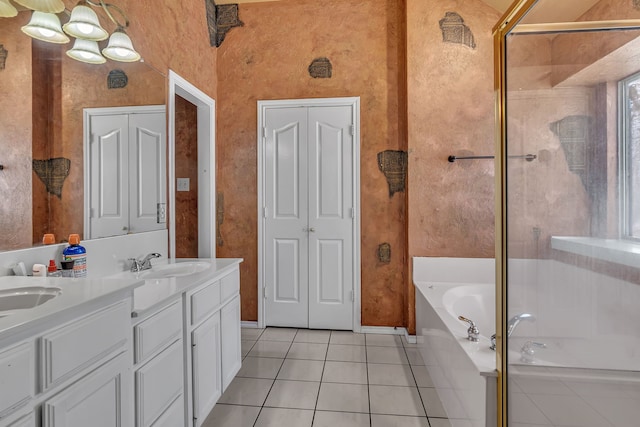 full bath with double vanity, tile patterned floors, a sink, a shower stall, and a bath