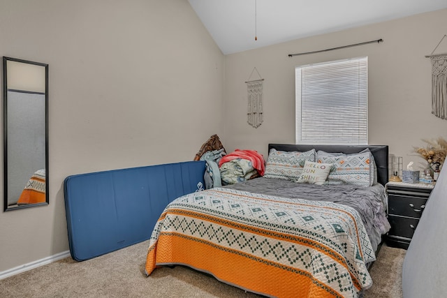 bedroom with baseboards, vaulted ceiling, and carpet flooring